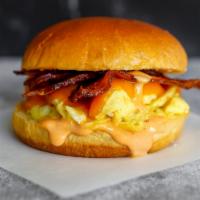 Bacon, Egg And Cheddar Sandwich · 2 scrambled eggs, melted Cheddar cheese, smoked bacon, and Sriracha aioli on a brioche bun