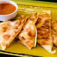 Roti Telur · A traditional Indian pancake filled with egg, onion and green chilies. Served with curry chi...