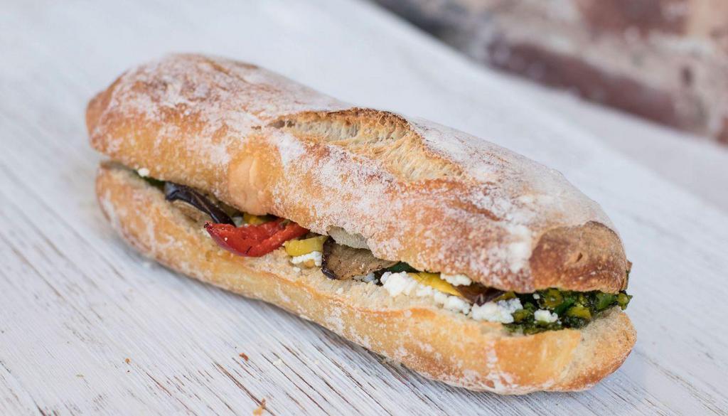 Roasted Veggie Goat Cheese Pistachio Pesto On Focaccia · Delicately roasted summer veggies (zucchini, eggplant, red peppers) with goat cheese and a delicious nutty pistachio pesto, on a ciabatta 
**Available 05/02**