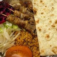 Lamb Shish Kebab Platter · Grilled lamb meat served with rice, lettuce, purple salad, tomato and pita bread.