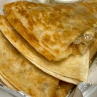 Gyro Quesadilla · 12-inch flour tortilla with lamb gyro meat and melted  Cheese, served with white sauce.