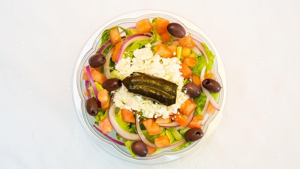 Greek Salad · Lettuce, tomato, onion, olives, feta cheese, stuffed grape leaves, extra virgin olive oil, and lemon juice.
