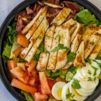 Cobb Salad · Grilled chicken, bacon, eggs, avocado, romaine lettuce, tomato, parsley and scallion.