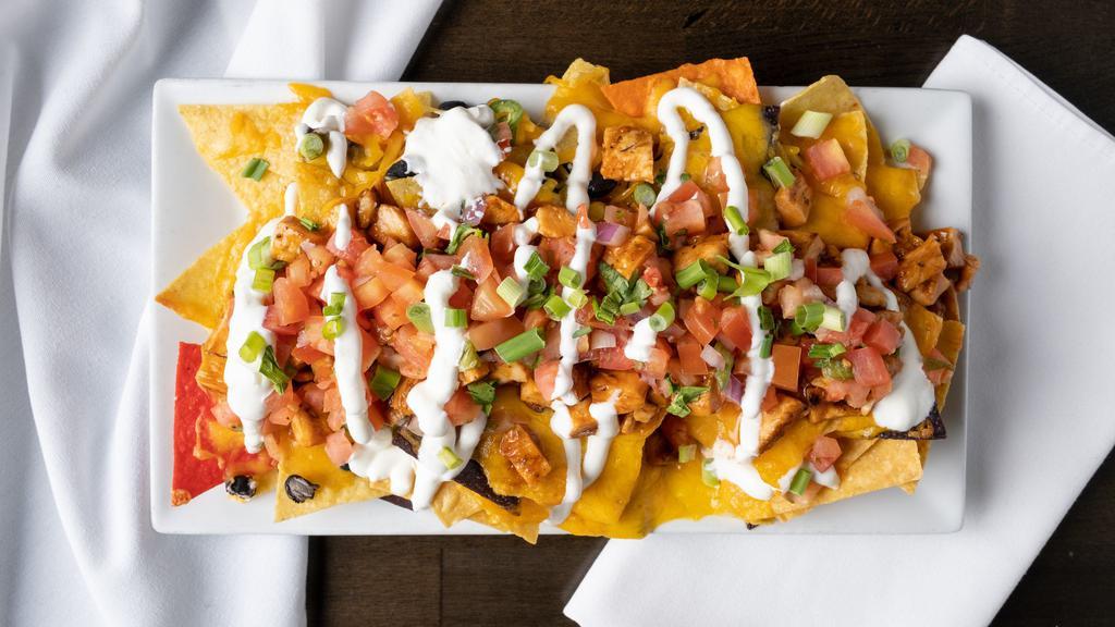 Jackie B'S Nachos · fresh tortilla chips, black beans, jalapenos, aged cheddar, beer cheese sauce, pico de gallo and sour cream. Choice of pulled chicken, pulled bbq pork, smoked brisket or cheese steak.