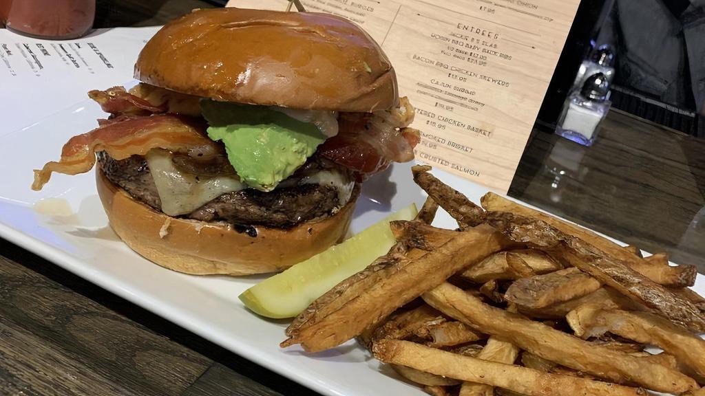 The Jackie B Burger · 8 oz Black Angus Beef Patty topped with applewood smoked bacon, caramelized red onion, avocado, white cheddar, Jackie B's sauce, served on a brioche bun.