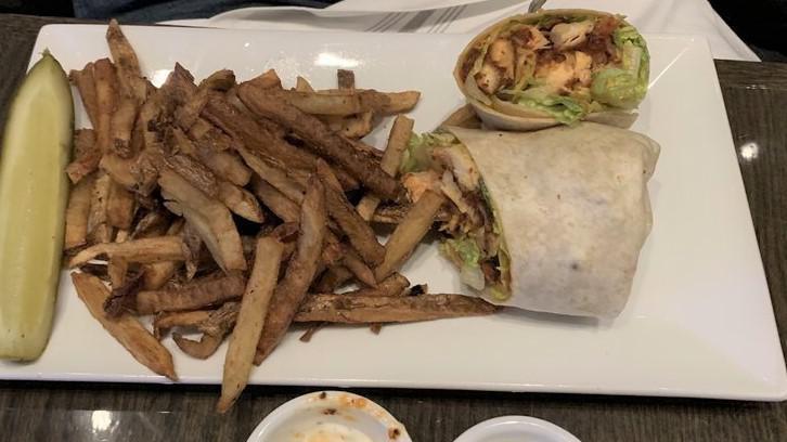 Buffalo Chicken Wrap · Crispy buffalo chicken breast, lettuce, tomato, applewood smoked bacon, and blue cheese served in a wrap.
