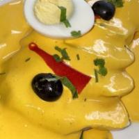 Papa A La Huancaina · Sliced potato topped with our homemade creamy yellow sauce.