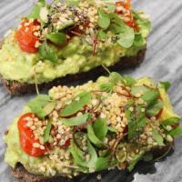 Avocado Tartine · Served on toasted house baked seed bread with roasted heirloom tomatoes