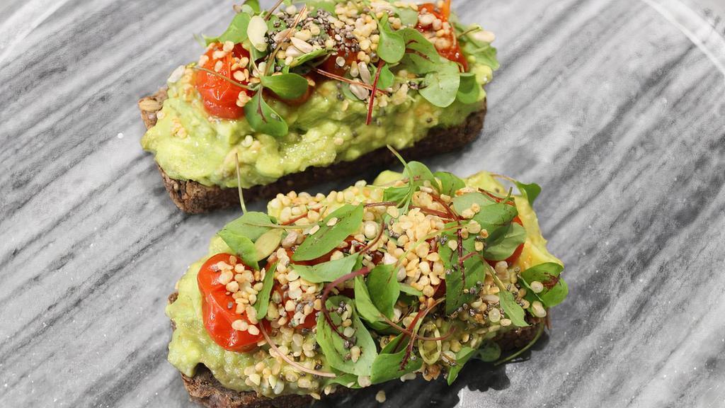 Avocado Tartine · Served on toasted house baked seed bread with roasted heirloom tomatoes