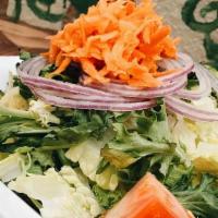 Tossed House Salad · Our classic house salad features mixed greens, crunchy slices of red onions, tomatoes, and d...