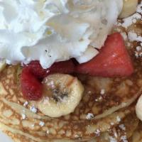 Strawberry Banana Pancakes · 4 Buttermilk pancakes filled with fresh banana slices topped, with glazed strawberries & ban...