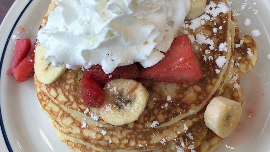 Strawberry Banana Pancakes · 4 Buttermilk pancakes filled with fresh banana slices topped, with glazed strawberries & bananas slices.