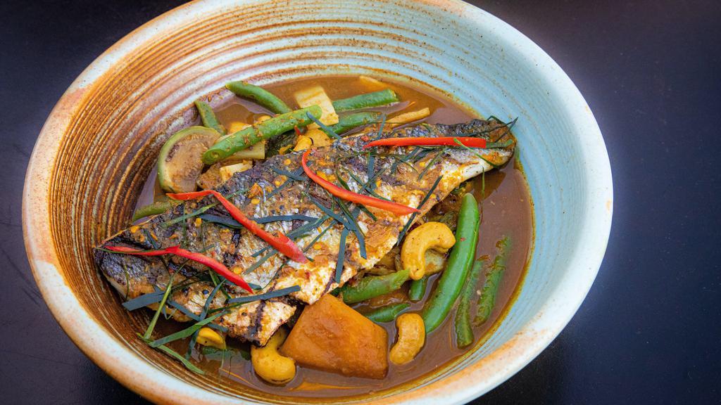 Kaeng Tai Pla · Grilled Bronzino with southern style curry, bamboo, string bean, kombucha squash, and cashew nut. (Spicy, Gluten free)