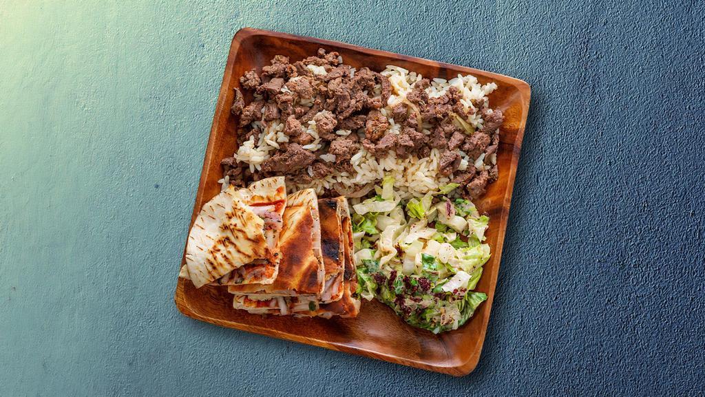 Beef-Lamb Shawarma Dinner · Beef and lamb shawarma dinner served with rice and salad.