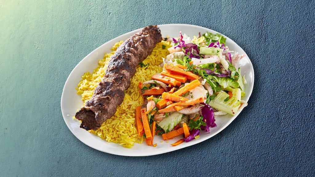 Lamb Kabob Combo Dinner · Lamb kabob combo dinner made of tahini, sauce spicy house sauce, pita bread, and pickles served with rice and salad.
