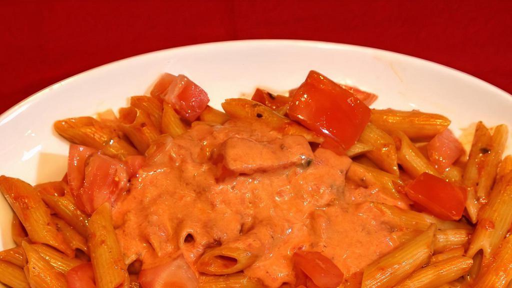 Penne Ala Vodka (Gf) · Penne with fresh tomatoes in a creamy pink vodka sauce. Gluten free penne or spaghetti available for an additional price.