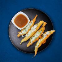 Golden Pepper Fritters (Vegan) · Banana Peppers slit and dipped in gram flour batter and deep-fried till golden. Served with ...
