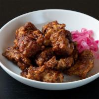 Soy Garlic Fried Chicken (Lg) · Crispy fried chicken thighs tossed with a savory sauce of soy, garlic and ginger.