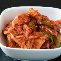 Napa Cabbage Kimchi · Traditional napa cabbage kimchi, marinated with spicy pepper flakes, garlic, ginger, and sca...