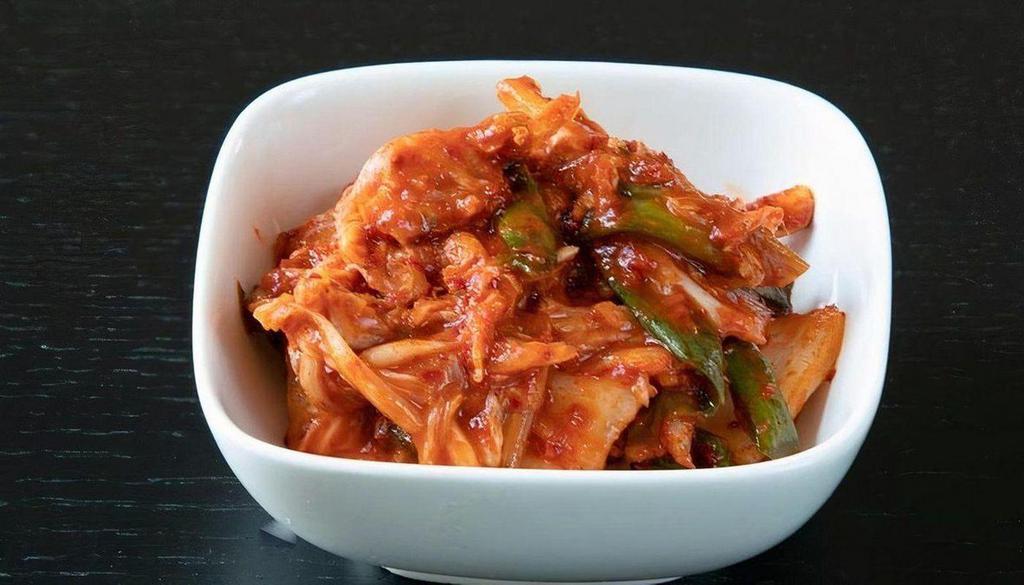 Napa Cabbage Kimchi · Traditional napa cabbage kimchi, marinated with spicy pepper flakes, garlic, ginger, and scallions.