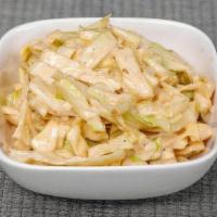 Green Cabbage Slaw · Shaved green cabbage and a roasted sesame dressing.