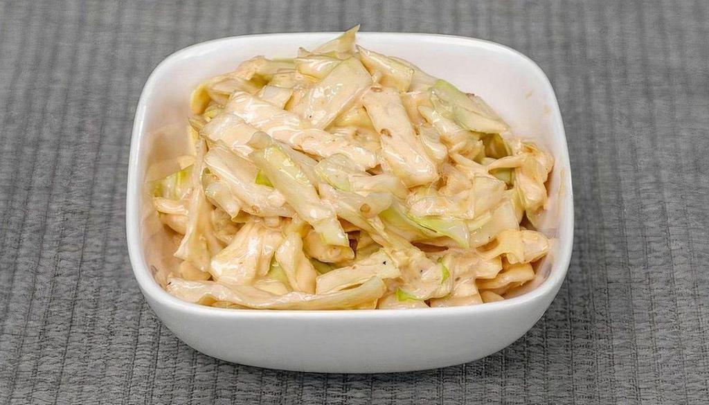 Green Cabbage Slaw · Shaved green cabbage and a roasted sesame dressing.