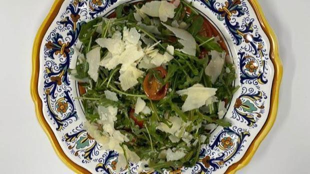 Rucola E Parmigiano · Arugula salad, shaved parmesan cheese, and cherry tomato.