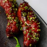 Ribs · In citrus glaze topped with garlic chives.