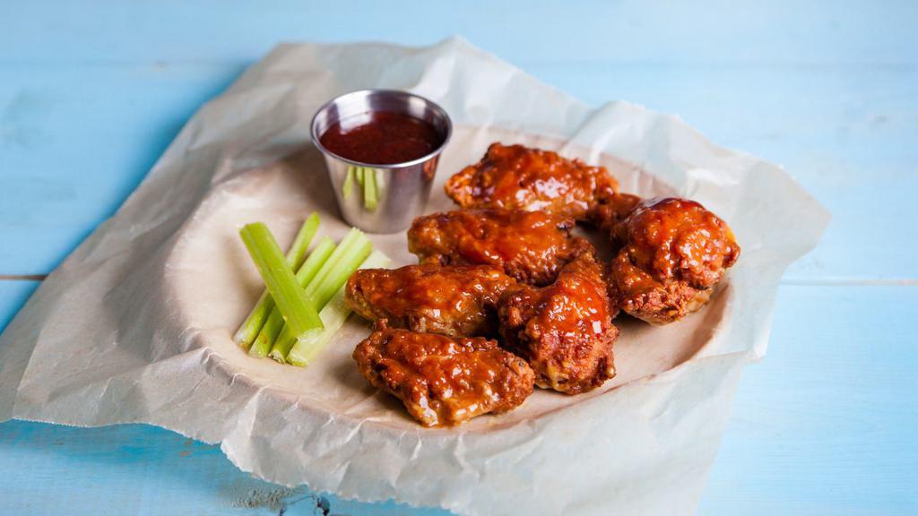 Hot Wings - Bone-In · Classic bone-in wings fried, topped with High-heat hot sauce, cooked to order and perfectly crisp.