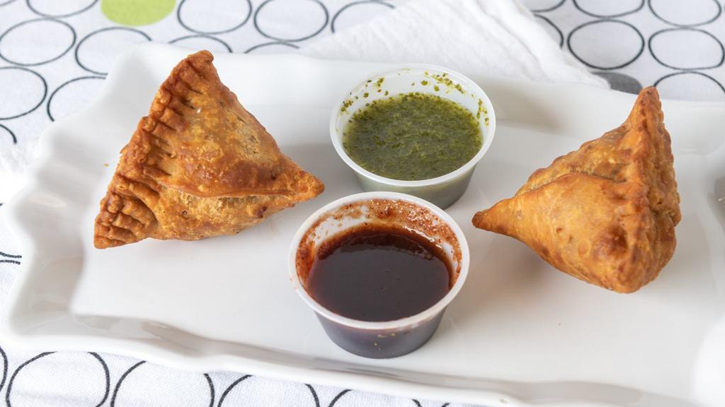 Samosa (2 Pieces) · Fried savory past, filled with spiced potatoes, onions, peas and lentil.