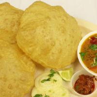 Poori Koorma · A fully deep fried whole wheat bread served with potato and greenpeas curry.