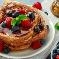 French Toast · Thick toast soaked in a rich eggy custard and griddled until golden brown. Served with real ...