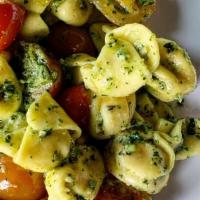 Truffle Ricotta Pasta Purses · Kale Pesto with Sunflower and Pumpkin Seeds | Heirloom Tomatoes