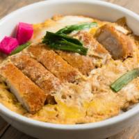 Katsu Donburi · Pork cutlet and vegetable cooked in egg sauce. Served on rice.