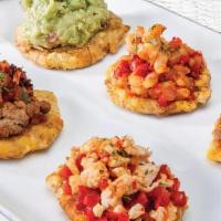 Tostones Noches · Fried smashed plantains topped with sautéed chicken, beef, shrimp & guacamole.