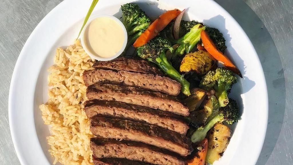 Bison Bowl · Lean ground bison with sautéed carrots, zucchini, and broccoli served over brown rice. Paired with a creamy cashew sauce.