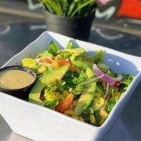 Vegan Cobb · Romaine lettuce, tomatoes, chickpeas, avocado, corn and onions with an agave citrus sauce