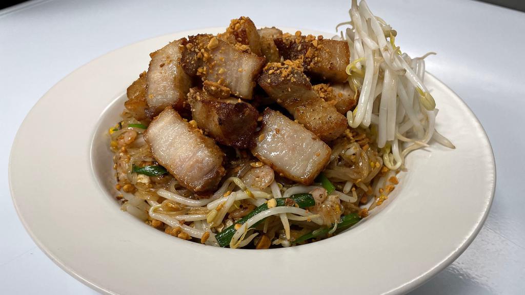 Rice Pot Pad Thai · Traditional thai noodle dish with rock shrimp and crispy pork belly. Rice noodles, pad thai tamarind sauce, egg, peanuts and vegetables.
