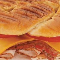 Turkey, Bacon & Cheddar · Oven-roasted turkey, crisp bacon, smoked cheddar and tomatoes with spicy mustard