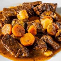 Beef Stew · Comes with the option of either white rice, yellow rice, rice with pigeon peas, or vegs.