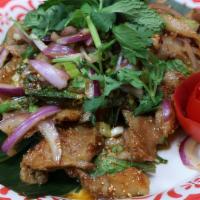 Nam Tok Pork · Sliced grilled pork mixed with red onion, lime juice, Thai herbs, roasted rice powder.