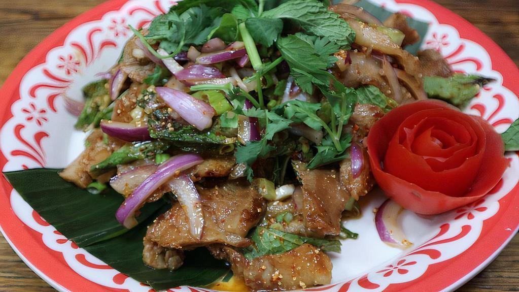 Nam Tok Pork · Sliced grilled pork mixed with red onion, lime juice, Thai herbs, roasted rice powder.