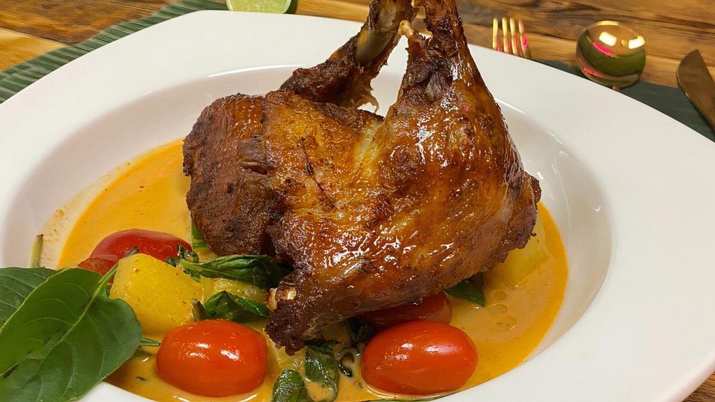 Duck Tropical Curry · Spicy. Crispy duck topped with red curry, coconut milk, bell pepper, pineapple, basil and tomatoes.
