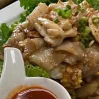 Guay Tiew Khua Gai · Wok fried flat noodle with chicken, squid, lettuce, egg, scallion and sesame oil.