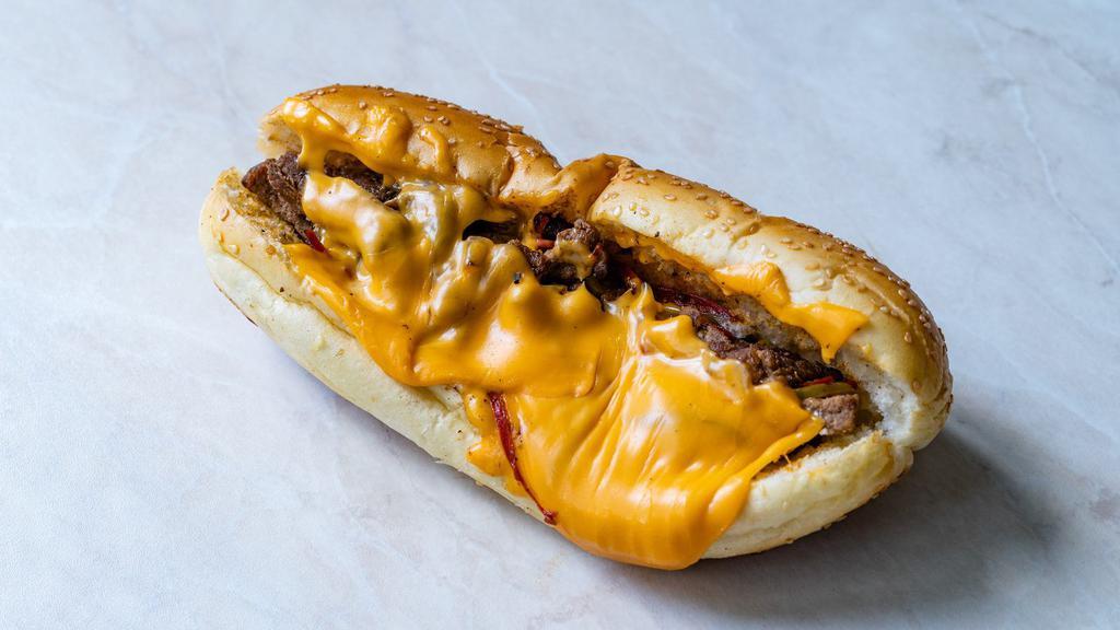Classic Philly Cheesesteak With Onions And Peppers · Thinly sliced steak with melted cheese topped with peppers and onions on a fresh-baked roll.