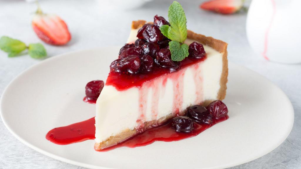 Slice Of Cherry Cheesecake · A rich and creamy New York-style cheesecake baked with cherries inside a honey-graham crust.