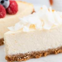 Slice Of Ny Famous Cheesecake · A rich and creamy New York-style cheesecake baked inside a honey-graham crust.