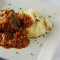 Braised Short Rib · Beef short rib in blu ale demi glaze served with mashed potatoes and root vegetables.