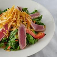 Ahi Tuna Salad · Seared ahi tuna over mixed greens, tossed with Asian vegetables, and sesame ginger dressing.