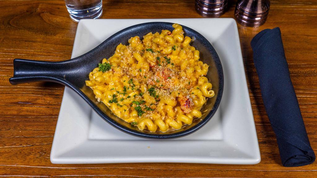 Lobster Mac & Cheese · Maine lobster tossed in house-made cheese sauce and cavatappi pasta topped with garlic breadcrumbs.